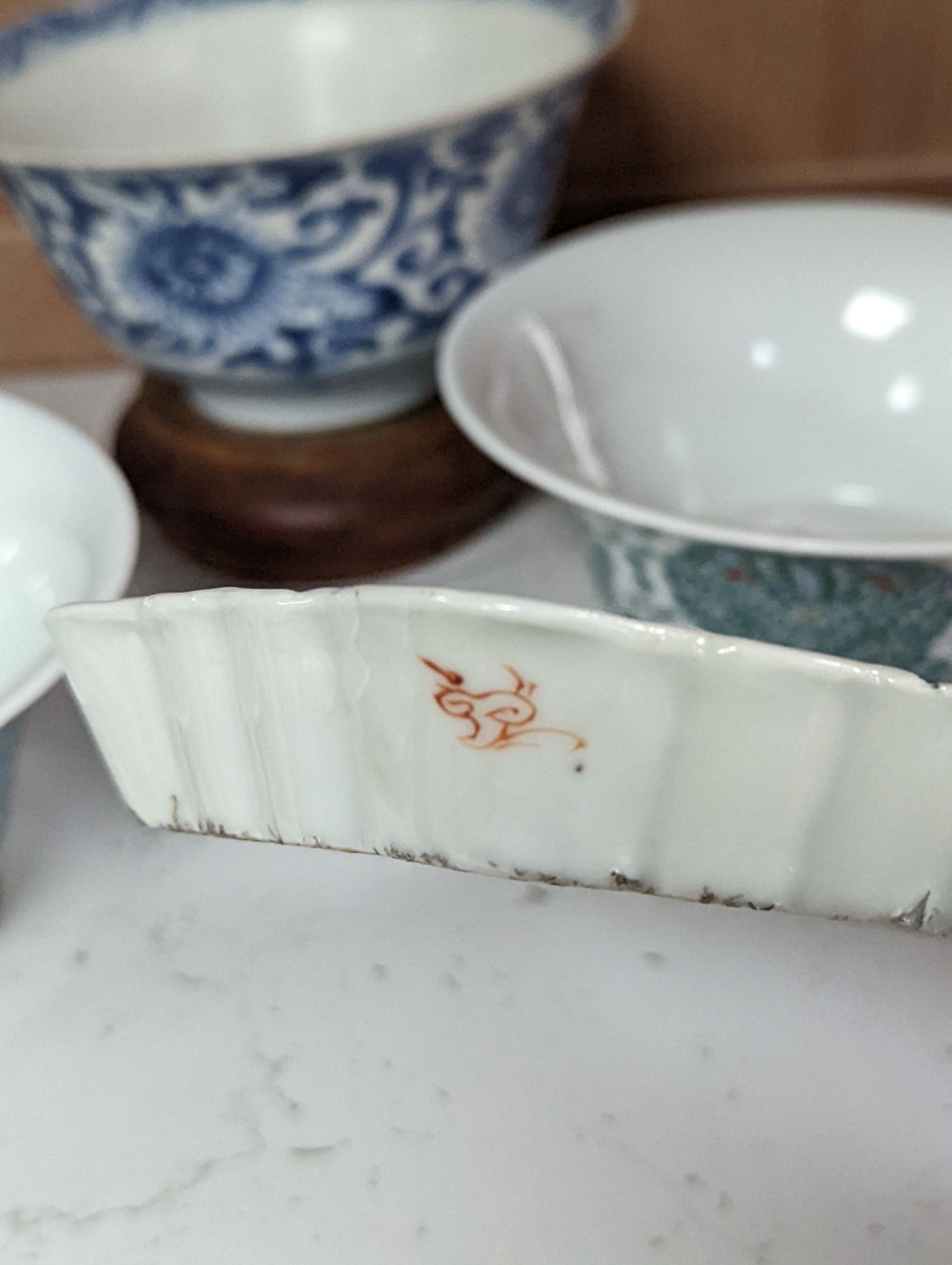 A Chinese blue and white bowl, Kangxi, 15cm. diam., a famille rose teapot stand, Yongzheng, and two doucai bowls